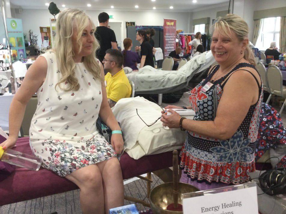 Visitors at an energy healing stand